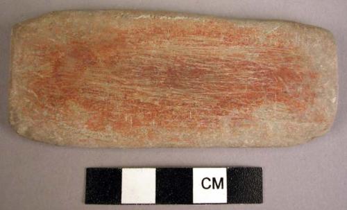 Stone pallette--showing red paint on one side, 3.5 x 1.5 in.
