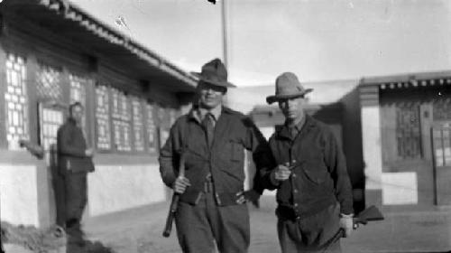 Two men standing outside of a building