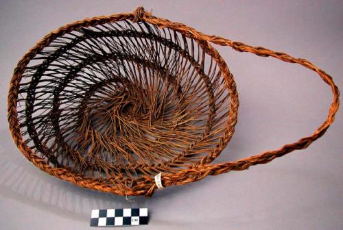 Basket, spiral open work, braided ribs and loop handle