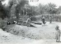 Life scene men making a small boat