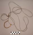 Cord, twisted fiber, one large loop, tied, one loosely twisted fragment