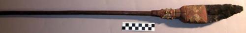 Carved wooden war club - end is flat and flared with point sticking +