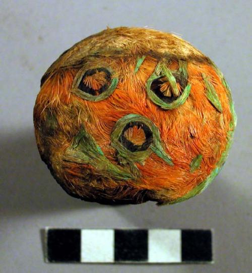 Pair of Mushroom shaped ear plugs with designs of orange and green feathers