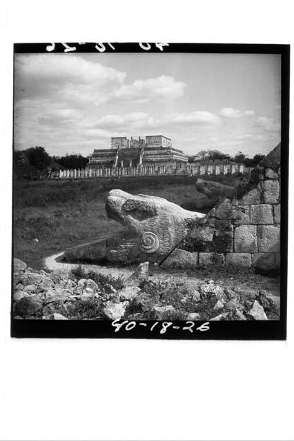 Serpents of balustrade of N. stairway of Castillo - Warriors in background