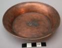 Copper shallow dish - character in center
