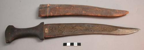 Iron knife in leather sheath - floral decoration on handle; animals etched on bl