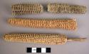 Corn cobs, one with twig handle