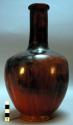 Long-necked black and red pottery vase