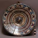 Majolica plate: tin-glazed earthenware with concentric bands of blue and purple