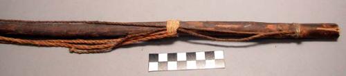 Wood stick, with sinew-wrapped ends, and twine running length