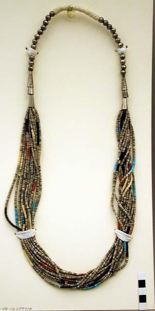 Necklace, 13 strands of tiny discoidal shell beads (heishi) and silver beads