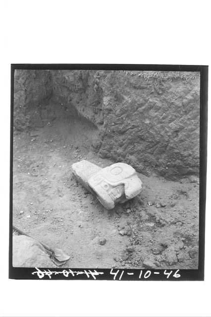 Angled view of stone head with face inside mouth; from Ballcourt A