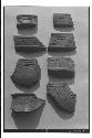 Potsherds, Miraflores coarse-incised black-brown ware bowls.