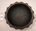 Dark-colored carved wooden bowl with scalloped edges, diameter of base: app. 9.5