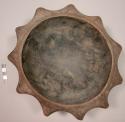 Carved wooden bowl with scalloped edges, rim of base pierced with string for han