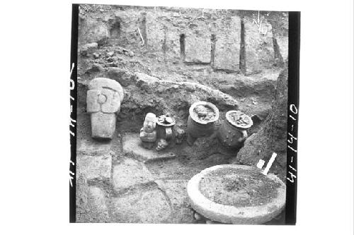 Stone and clay objects found on Altar A.  Photo from near stake N72.12W looking