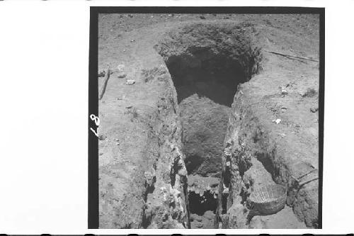 Looking down into deep pit at base of Mound 1. Vault of tomb is visible at base