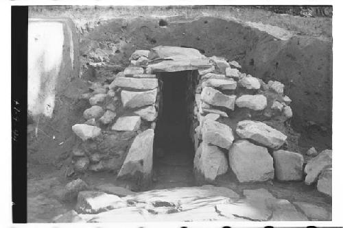 Entrance to underground passage from flagstone paved terrace