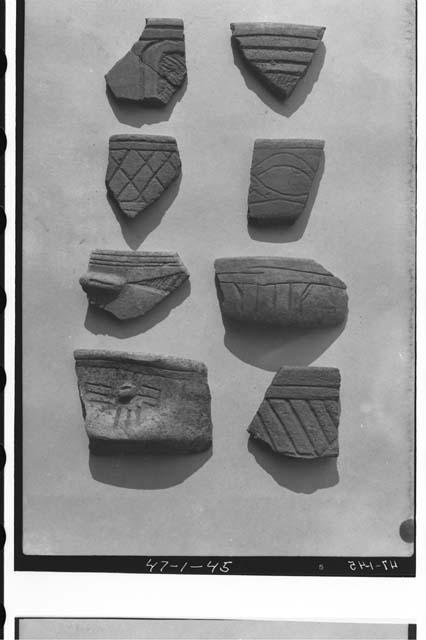 Potsherds, Miraflores coarse-incised black-brown ware bowls.