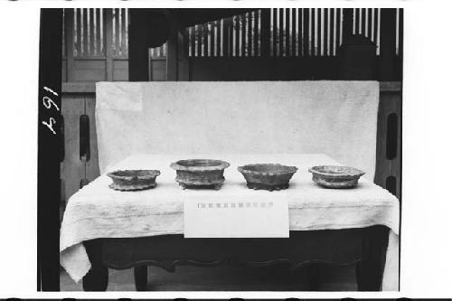 Four pottery vessels from tomb in ball court