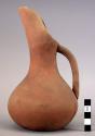 Ceramic, earthenware pitcher, rounded body, extended spout, strap handle