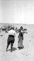 Two women standing in desert