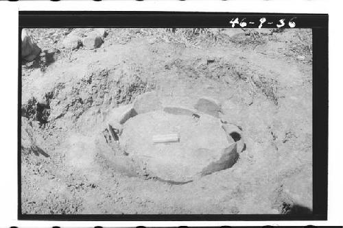 Burial Urn in situ. Burial of human skeleton with jade ornaments in large re war