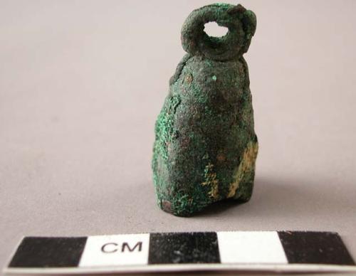 Broken copper bell with textile impression