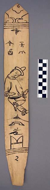 Ornament?, flat stick, black painted designs - man w/leg overlapping other leg