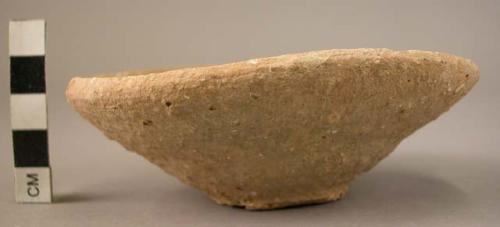 Irregular small flat pottery dish - extensive crushed lime grit;