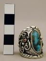 Silver ring w/ lg. oval turq. stone, sm. inlaid coral, silver floral motifs