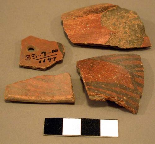 Ceramic sherds, black on red geometric designs, 1 undecorated, 1 perforation