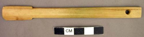 Bone spatula - perforated on one end; stained with copper