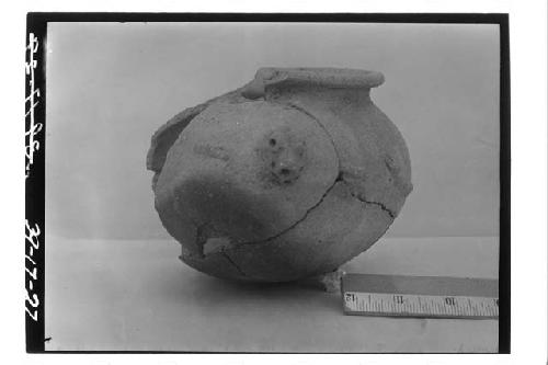 Front view of effigy pot found in hole dug south of tomb 1-39.