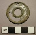 Pendant, fragmentary, discoidal, raised ridge around edges, per