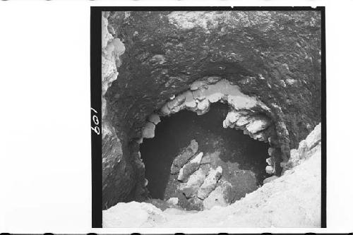 Looking down into tomb in Mound 1, capstones lined up on Tomb floor