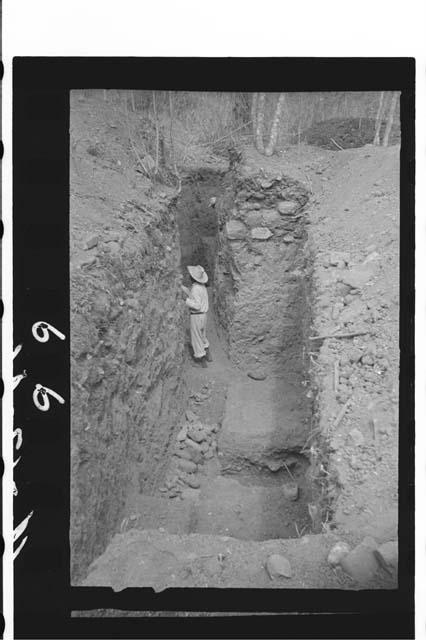 Laborer in trench 1-46 after excavating eastern end