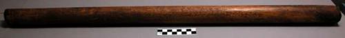 Hollow wooden tube (1 1/2" diameter) enclosing a fur tail on a bamboo +