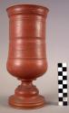 Ceramic, earthenware complete vessel, turned, pedestal base, cylindrical form, flared rim, red slipped exterior; mended