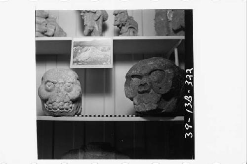 Two grotesque carved stone heads