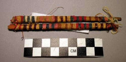 Wrapped sticks and yarns, a) l. 18 cm. 1.2 cm, 2 sections of cane wrapped togeth