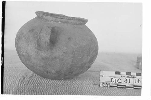 Globular pottery jar with two vertical strap loop handles