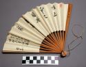 Fan in white with black inscriptions given as a souvenir