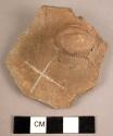 Potsherd showing lug grooved apparently for suspension