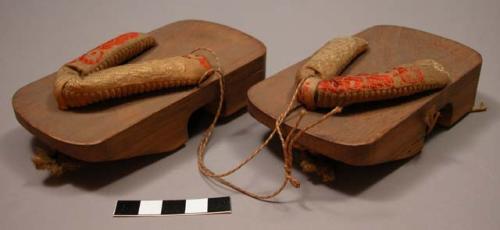 Pair of wooden Japanese shoes - footholds made of yellow and red silk
