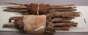 Organic, woven fiber, fiber wrapped cane sticks, bundled, with textile fragment