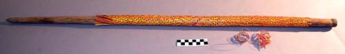 Wooden walking stick bound with red & yellow rattan