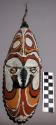 Carved polychrome painted (white, black, orange, red) mask with cowrie shell "ey