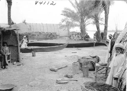 Life scene photograph of Marsh Arab men and children with small boats