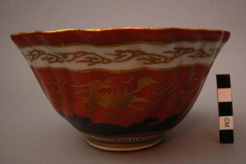 Ceramic bowl with rust, gold, blue, and white design